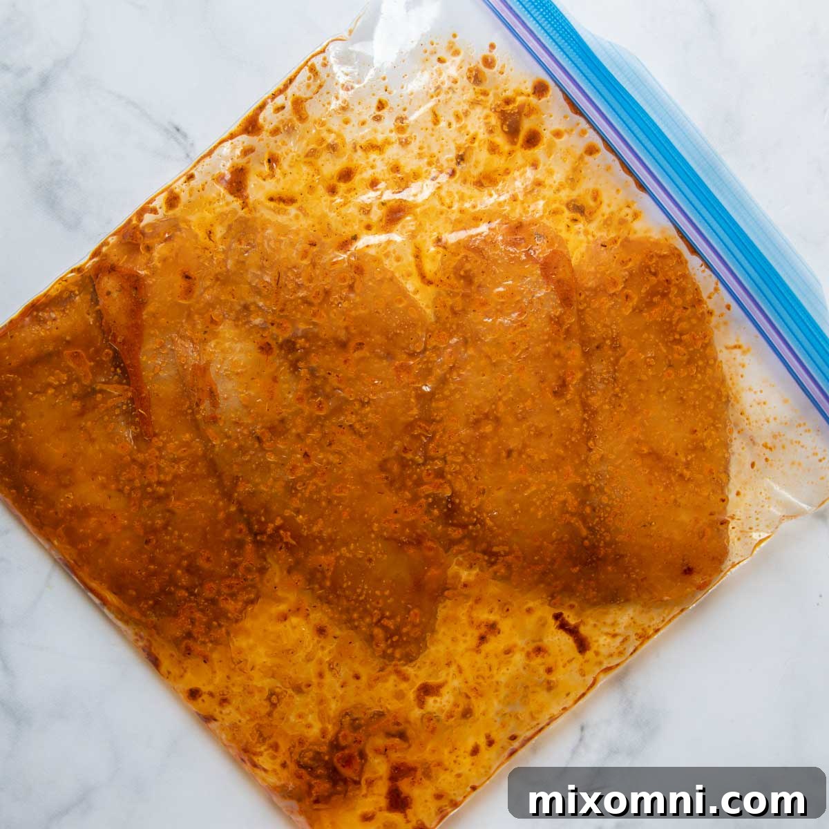 Fish marinating in a ziplock bag with blackened seasoning and lime juice