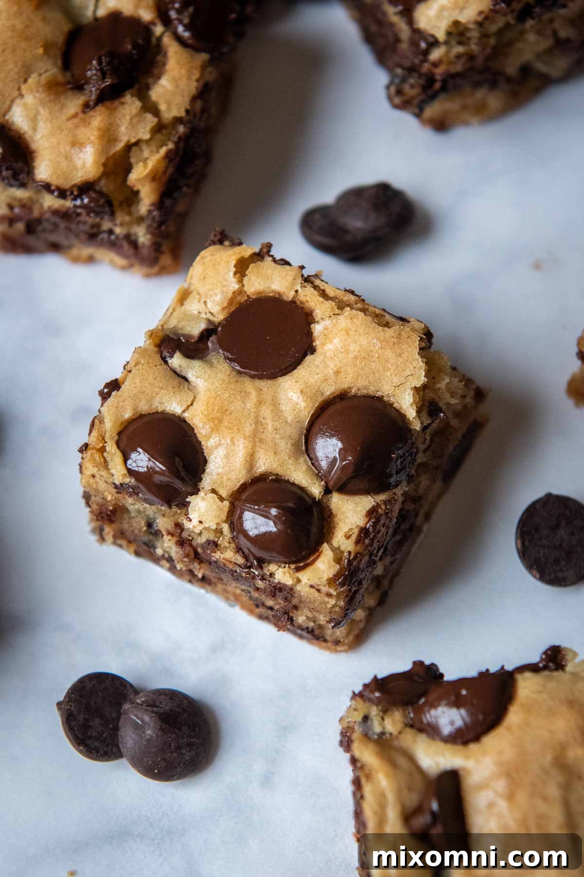 The top of a baked blondie with melting chocolate chips, illustrating a perfectly finished surface.