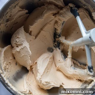 Close-up of fluffy peanut butter buttercream frosting in a bowl, ready for spreading.