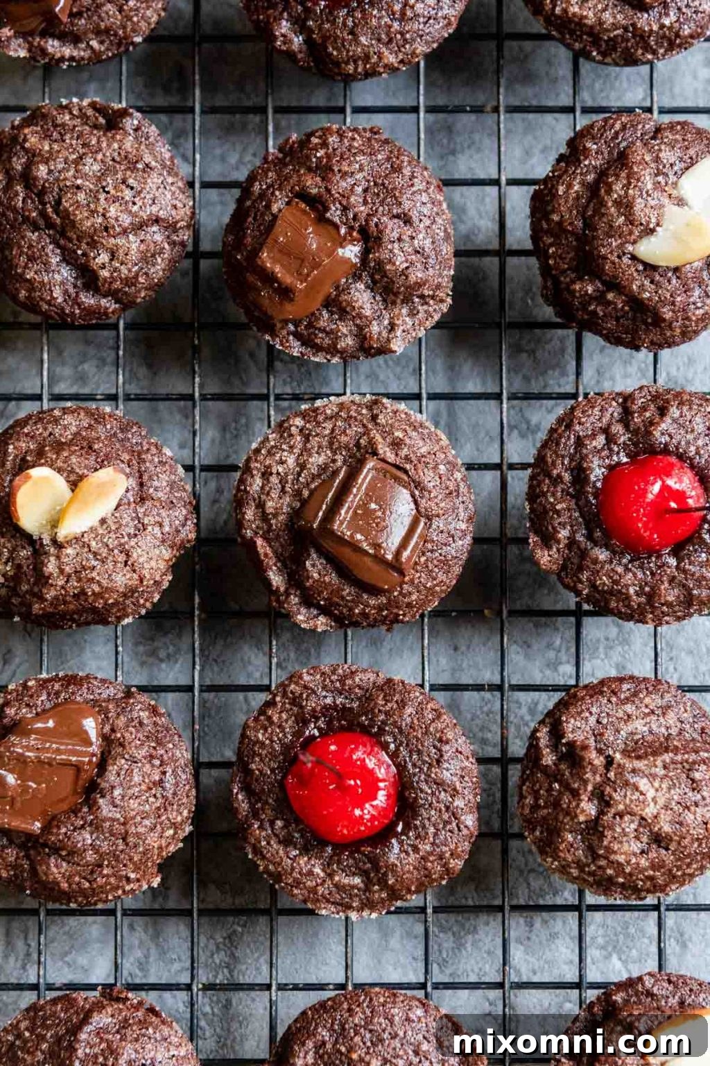 overhead shot of chocolate financiers on a black cooling rack