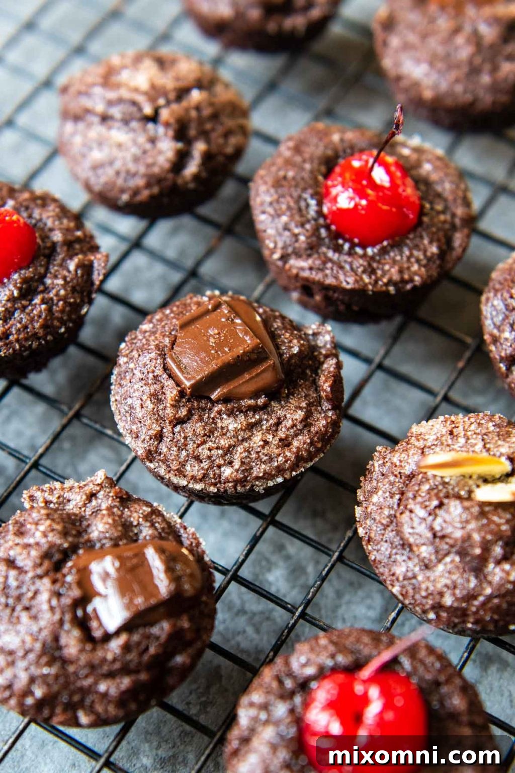 a close up of financiers with melted chocolate on top