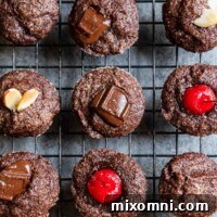overhead shot of chocolate financiers on a black cooling rack