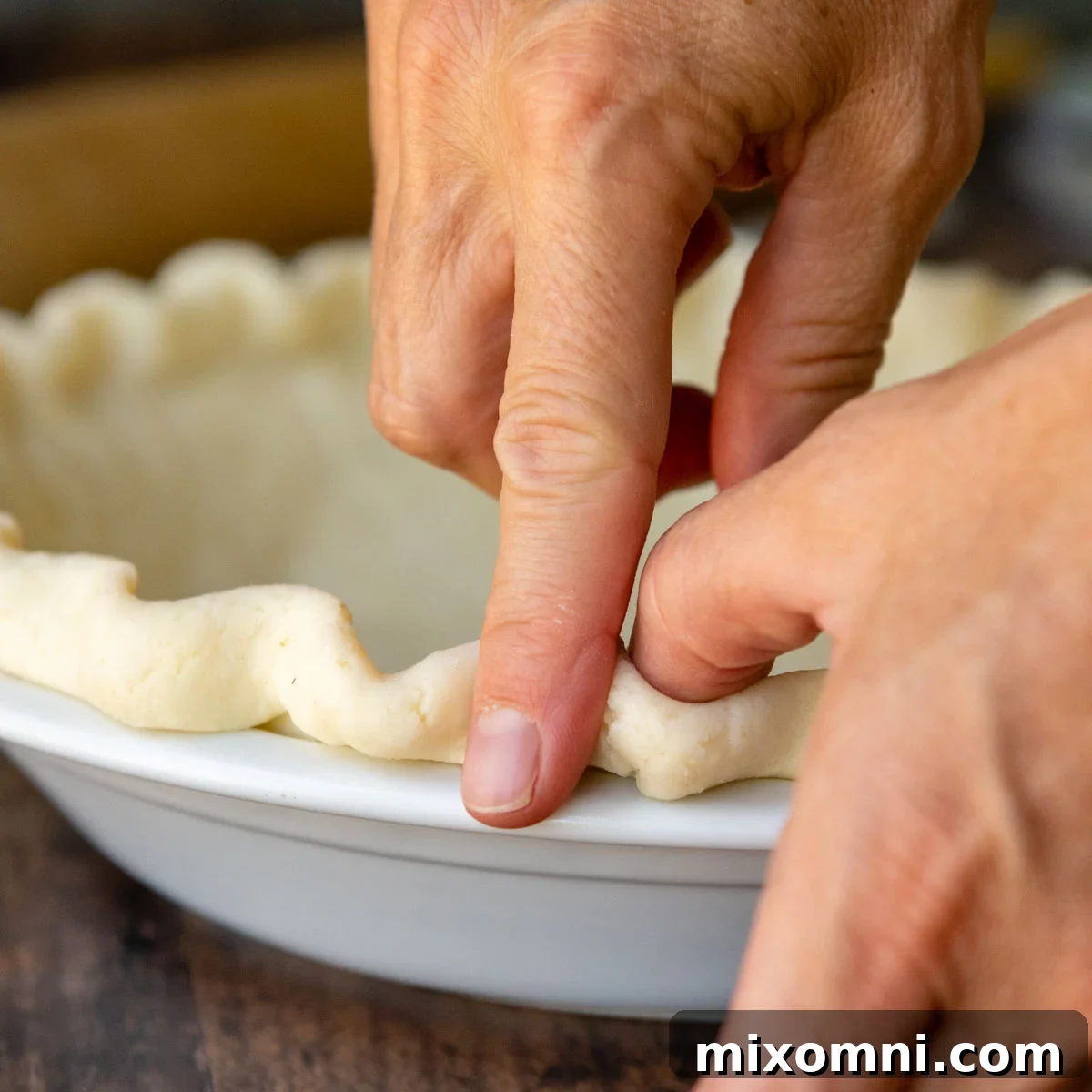fingers making a decorative edge around the GF crust.