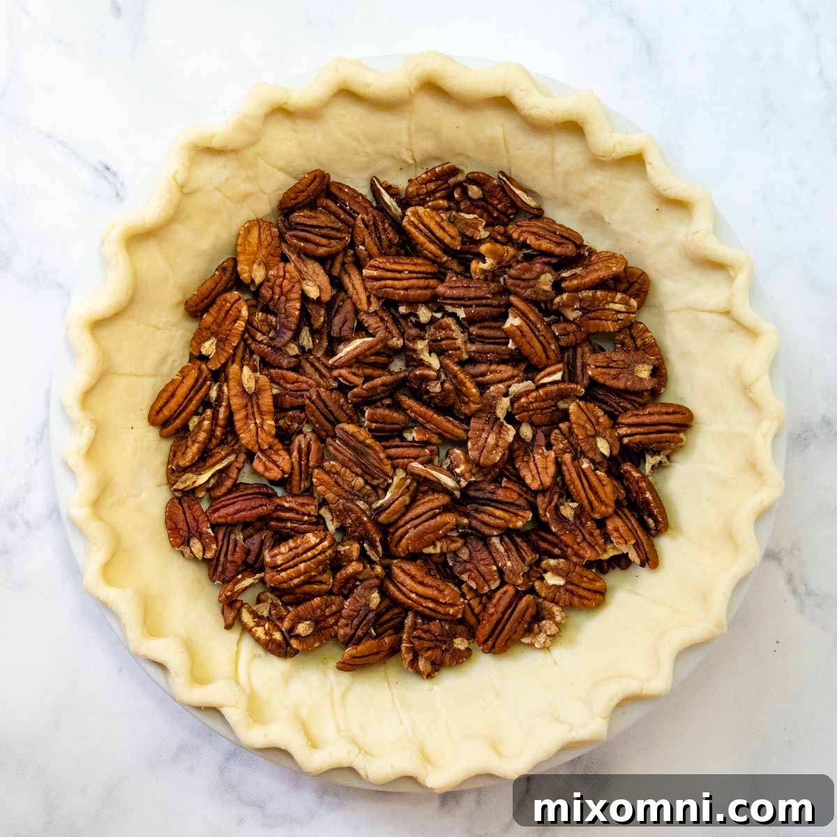 the pecans on the bottom of an unbaked pie crust.