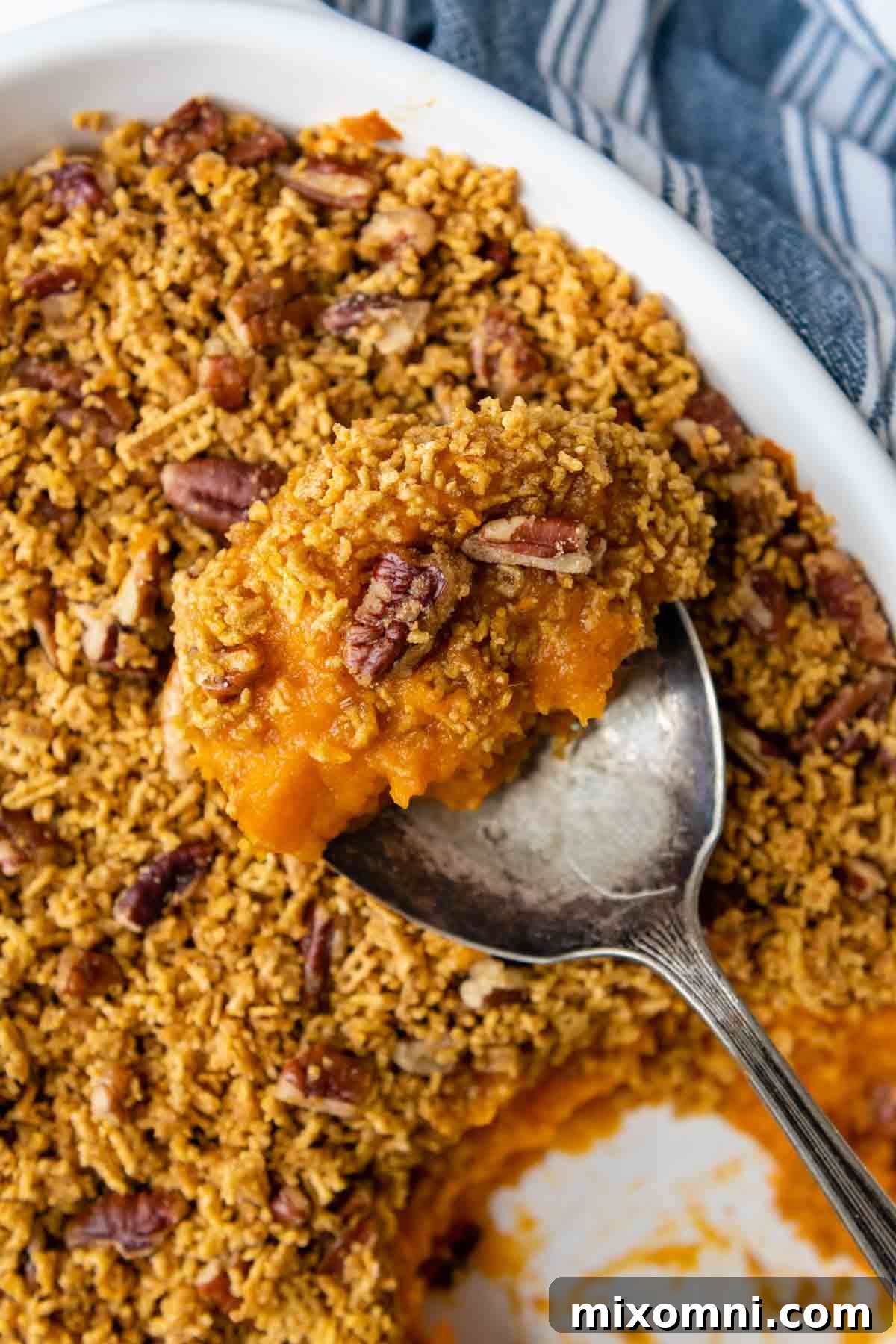 a spoon lifting out a serving of casserole.