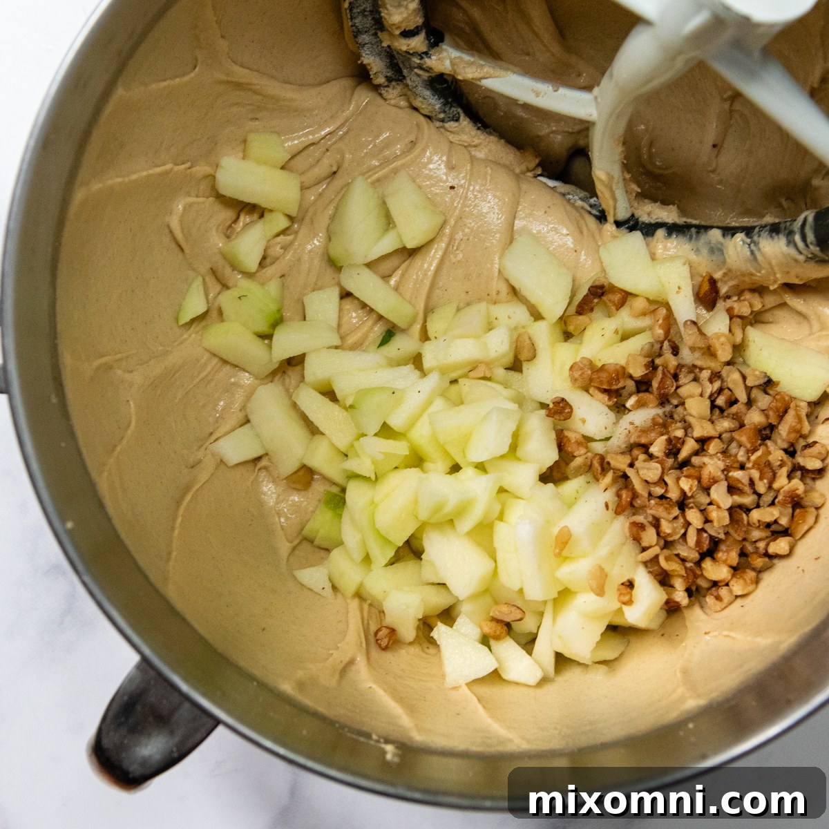 apple bread batter with chopped fresh apples and nuts.
