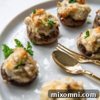 close up of stuffed mushroom on a white serving platter