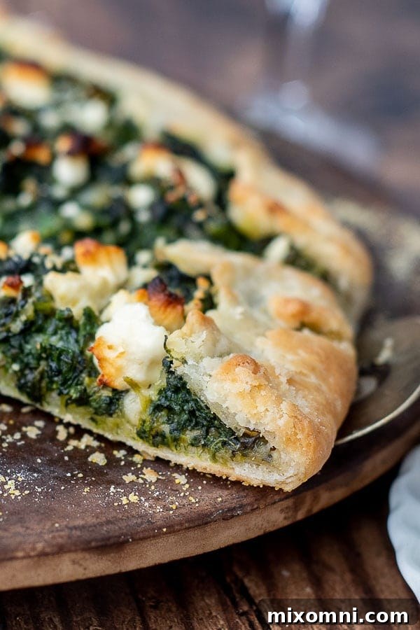 A close-up shot of the perfectly golden-brown, flaky crust of a Savory Vegetable Tart.