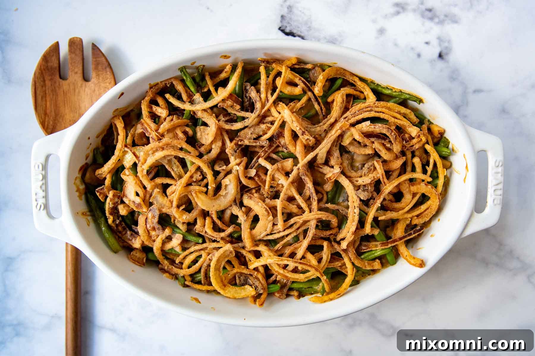 horizontal overhead shot of completed dish with a wood spoon laying next to it