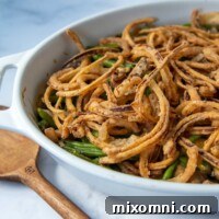 a close up shot of gluten free green bean casserole on a marble surface