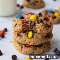 stack of three monster cookies with a bite taken out of top one