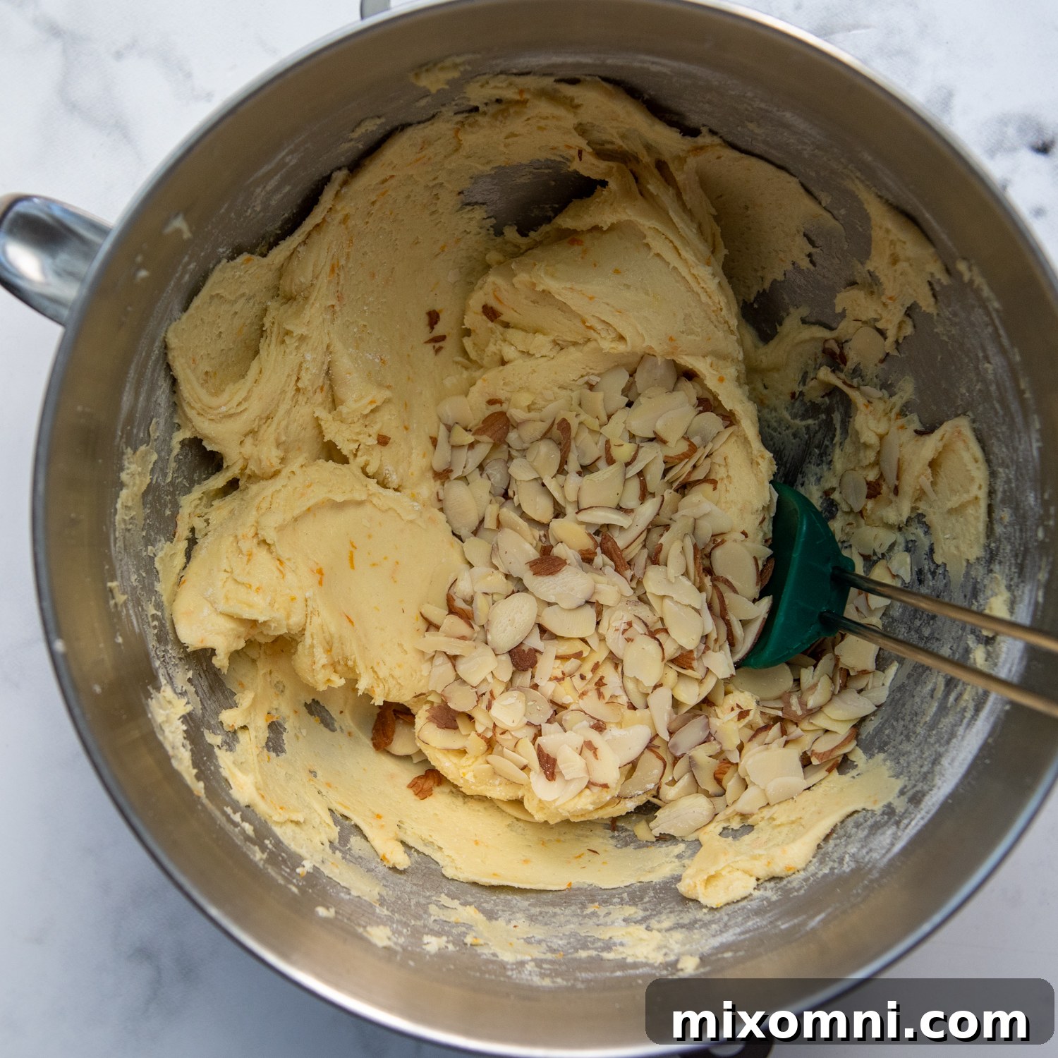 the dough mixed together with add ins, like sliced almonds