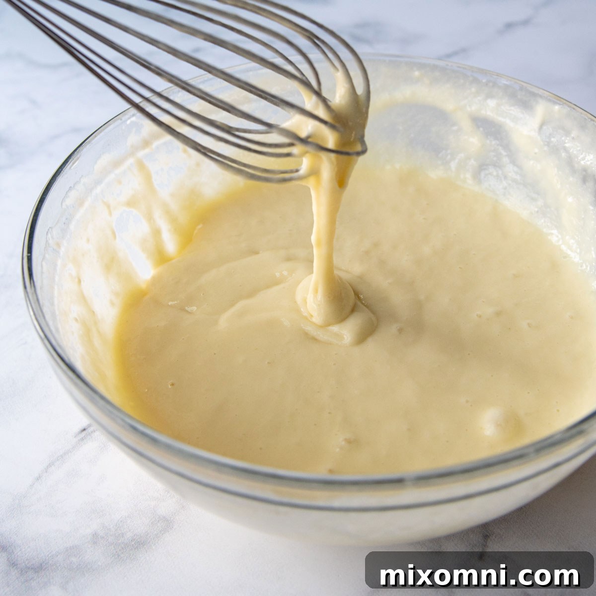 Gluten-free crepe batter in a bowl, showing its smooth, pourable consistency.