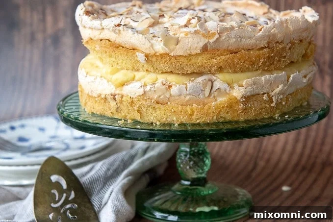 The entire unsliced Blitz Torte resting on a green cake stand.