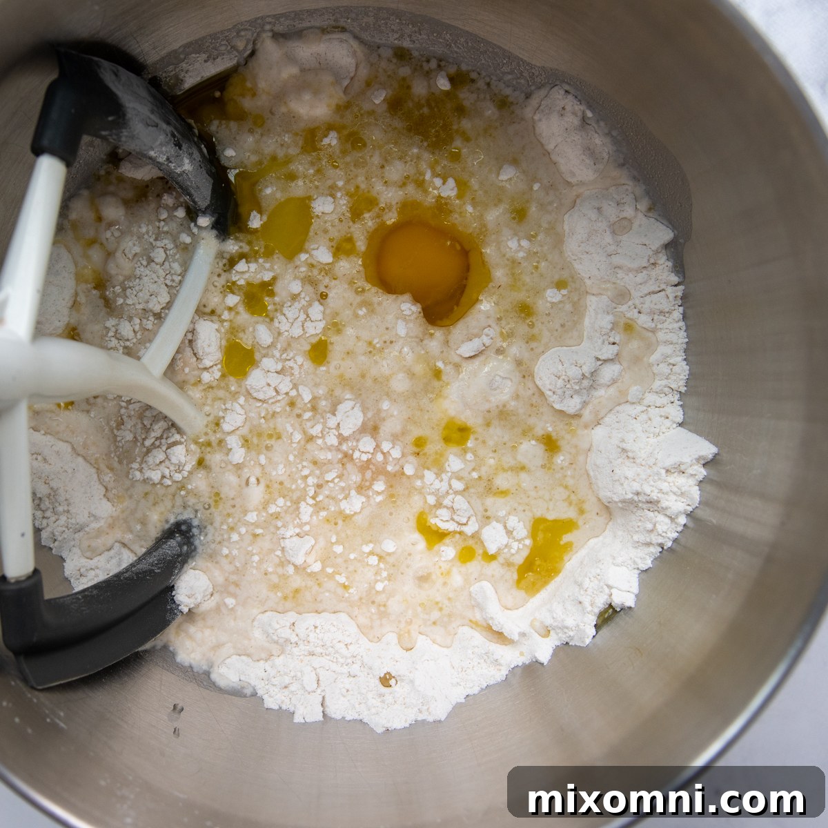 All dry ingredients for the breadsticks in a mixing bowl of a stand mixer, ready to be combined.