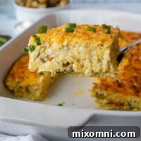 A spatula lifting out a slice of egg casserole