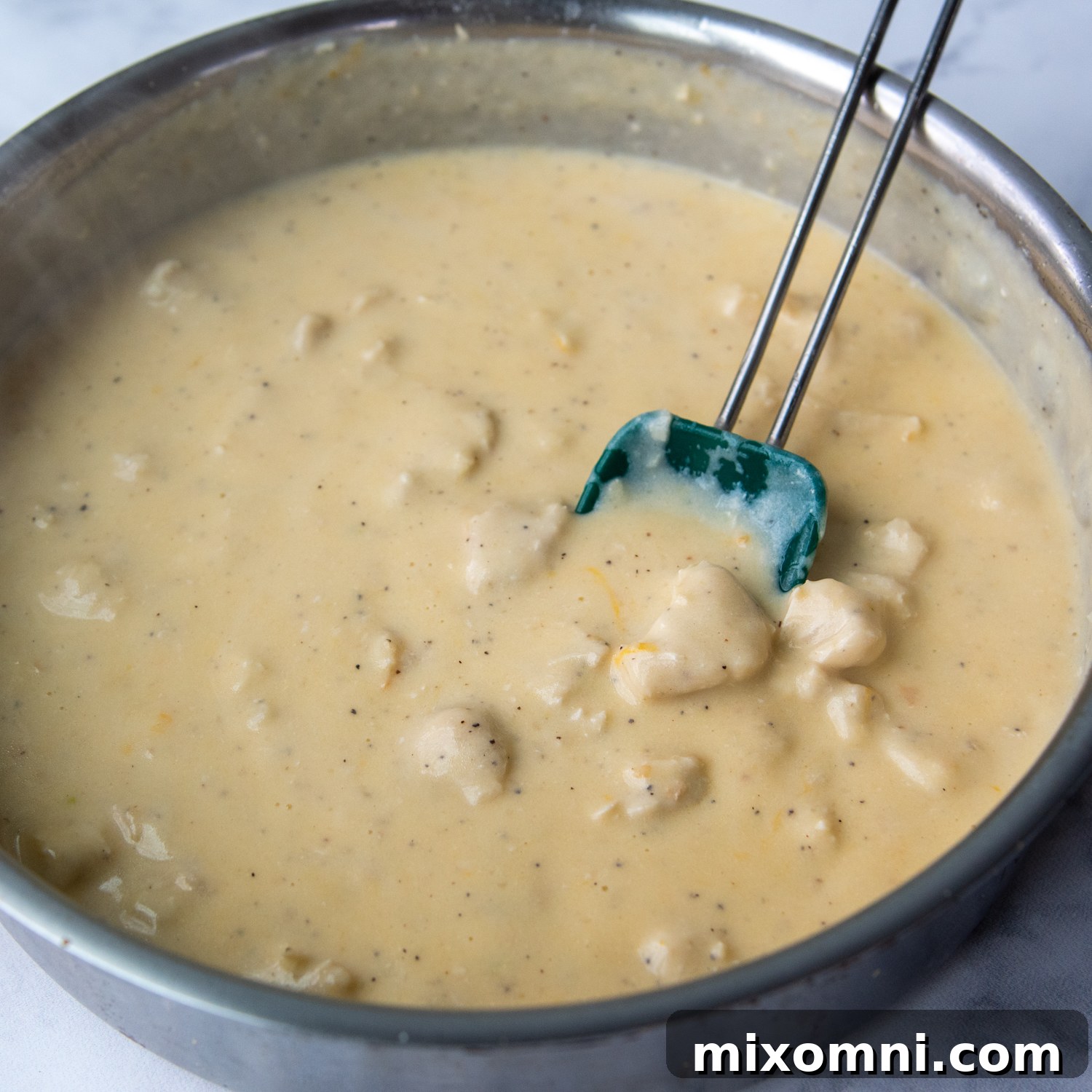 the cheese sauce finished off in a pan with cooked chicken.