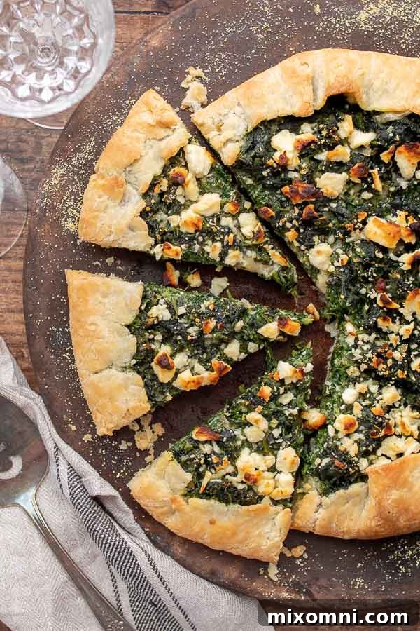 An overhead view of a beautifully baked vegetable tart, expertly cut into individual slices.