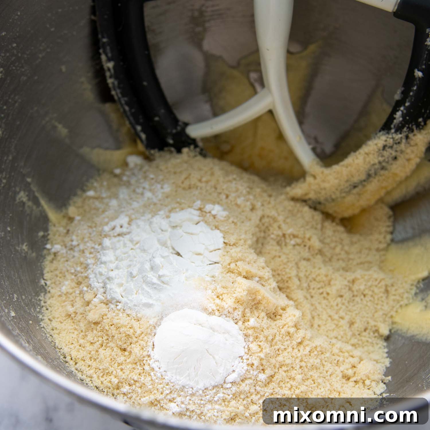Ingredients in a mixing bowl being combined to create the biscotti dough.