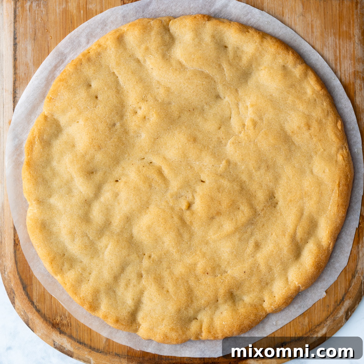 baked crust on a pizza paddle.