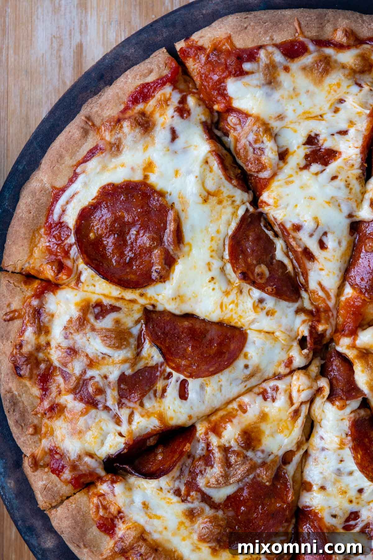 overhead shot of pepperoni pizza sliced
