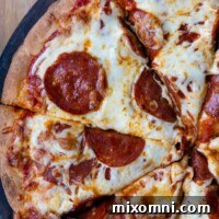 overhead shot of pepperoni pizza sliced