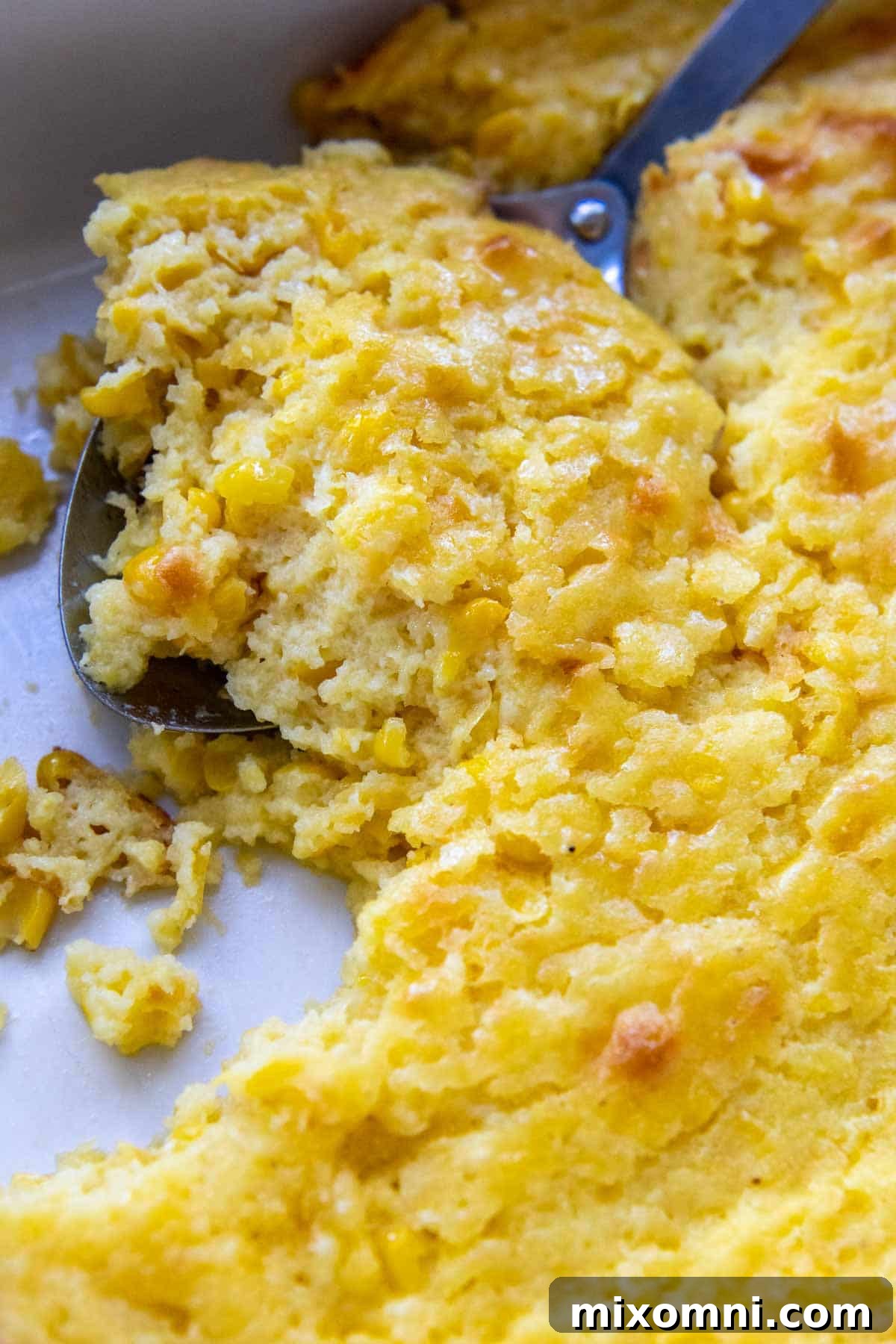 A close-up shot of a creamy and fluffy gluten-free cornbread casserole, ready to be served