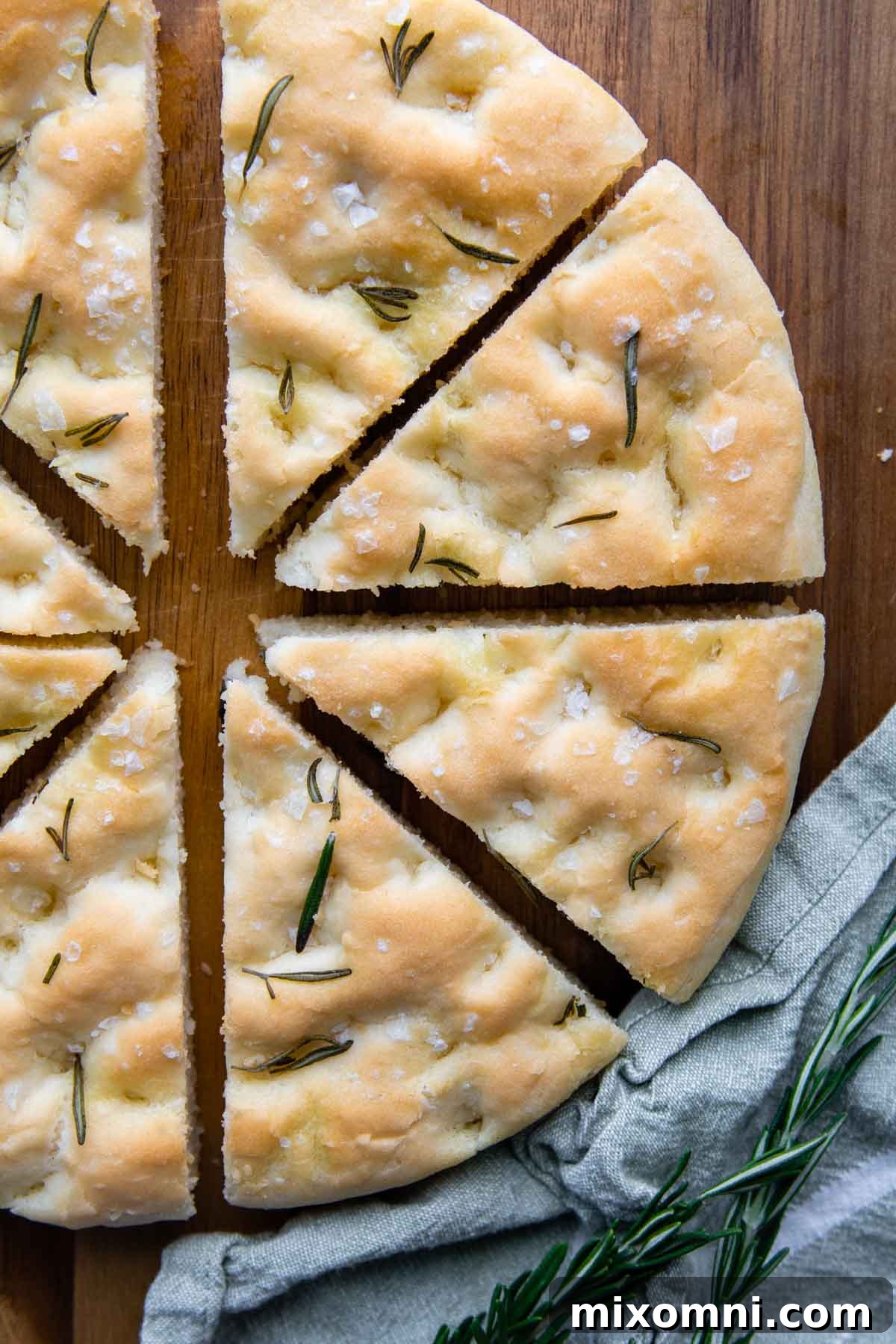 focaccia sliced in wedges on a wood cutting board