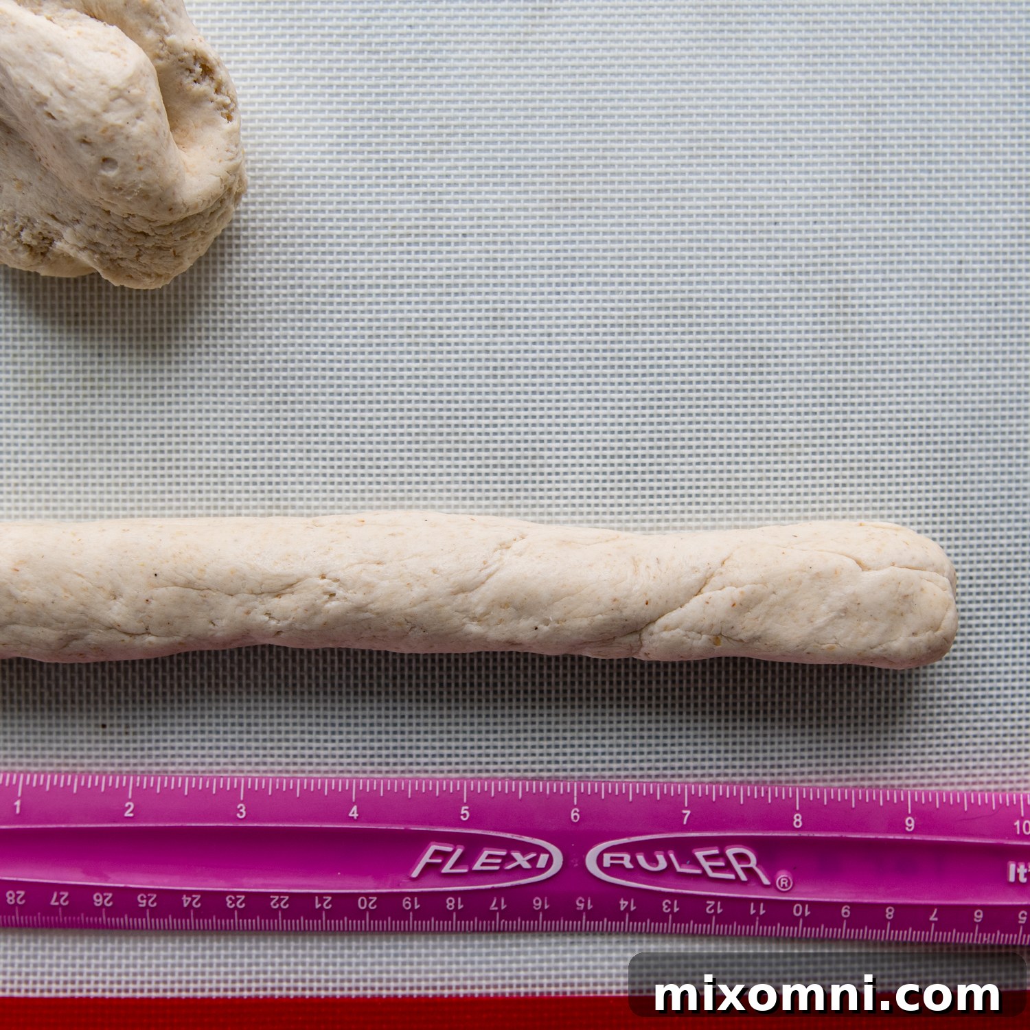 a ruler showing what the length of the bagel should be.