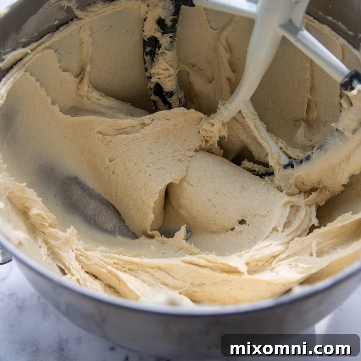 Gluten-free garlic knot dough in a stand mixer, perfectly mixed and ready for shaping.