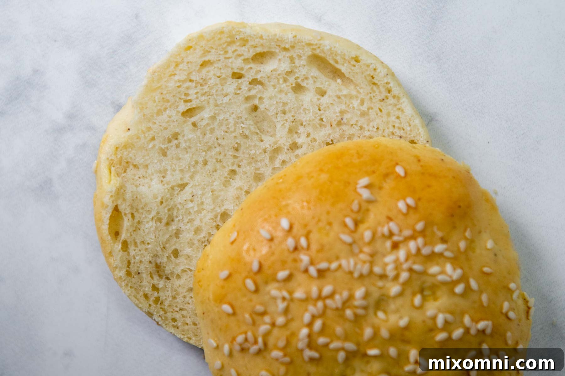 a cut open gluten free hamburger bun facing up.