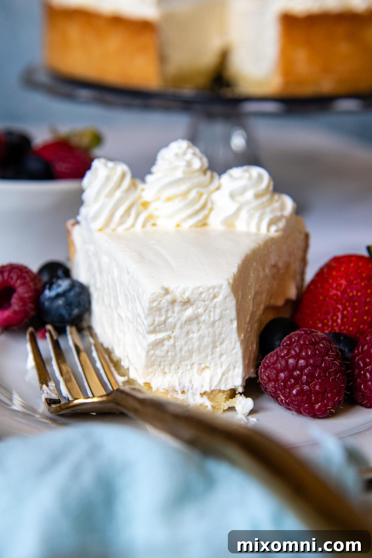 A perfectly sliced no-bake gluten-free cheesecake with a bite taken out, showcasing its creamy texture.