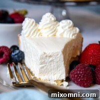 A slice of creamy gluten-free cheesecake with a bite taken out, perfect for sharing the recipe.