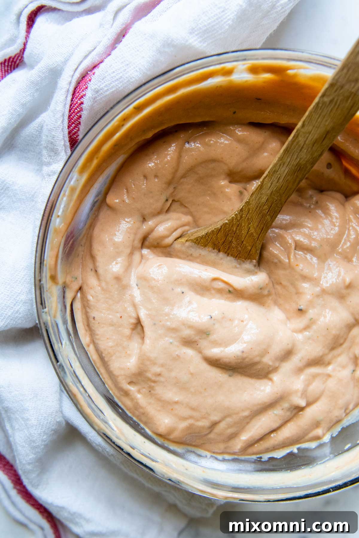 overhead shot of barbeque ranch with a wooden spoon in bowl.