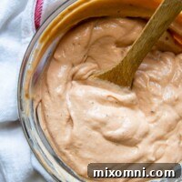overhead shot of barbeque ranch with a wooden spoon in bowl.
