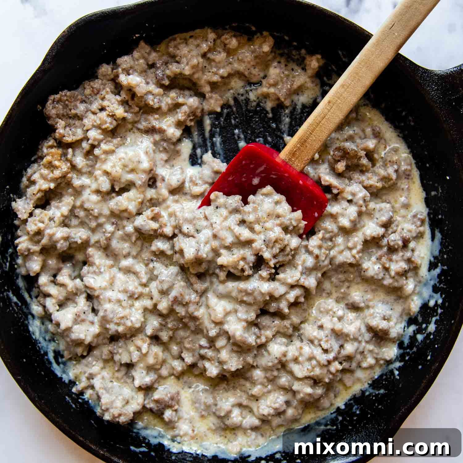 finished sausage gravy with a slightly thinner, creamy white sauce consistency.