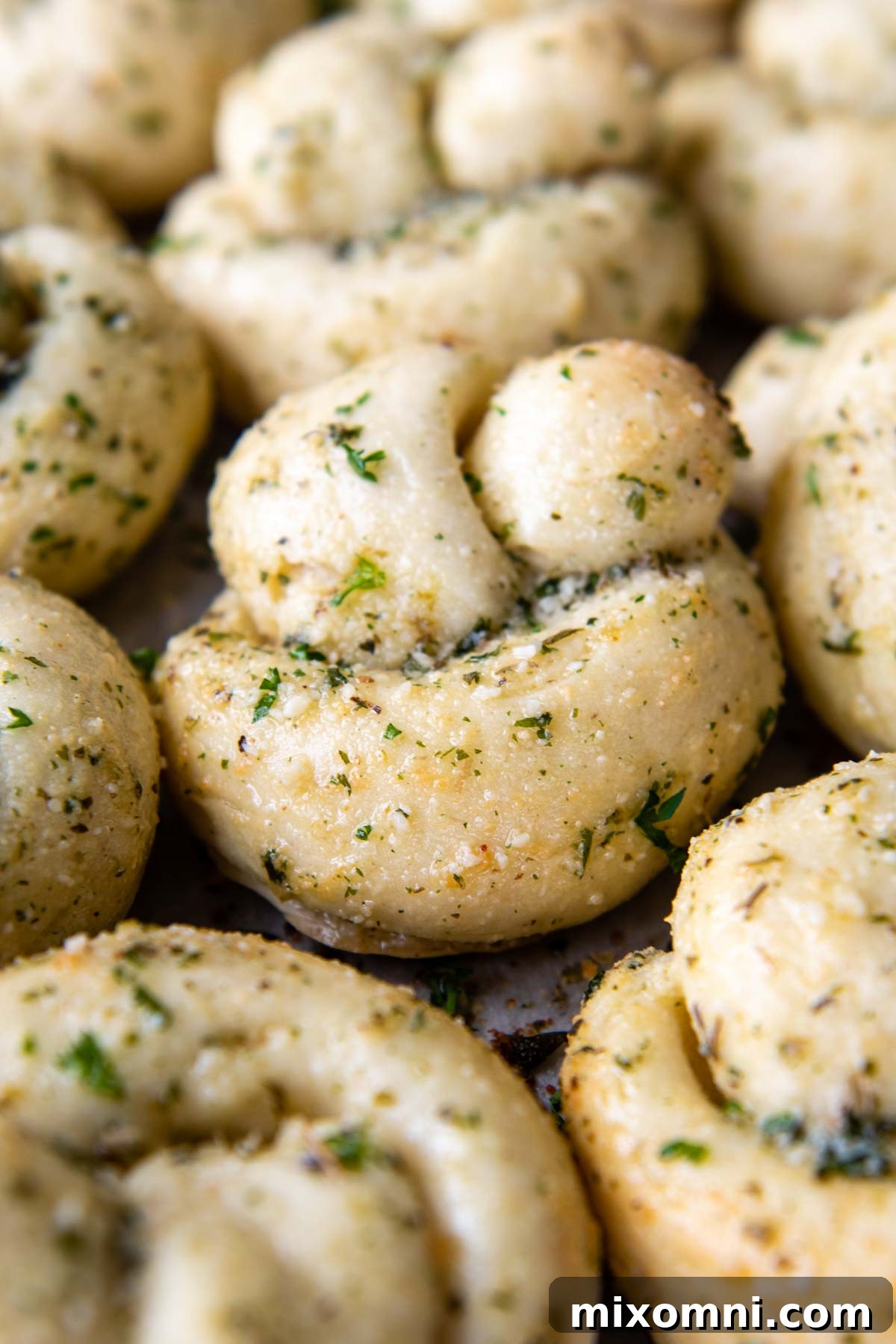 a close up of a garlic knots with garlic butter brushed on.