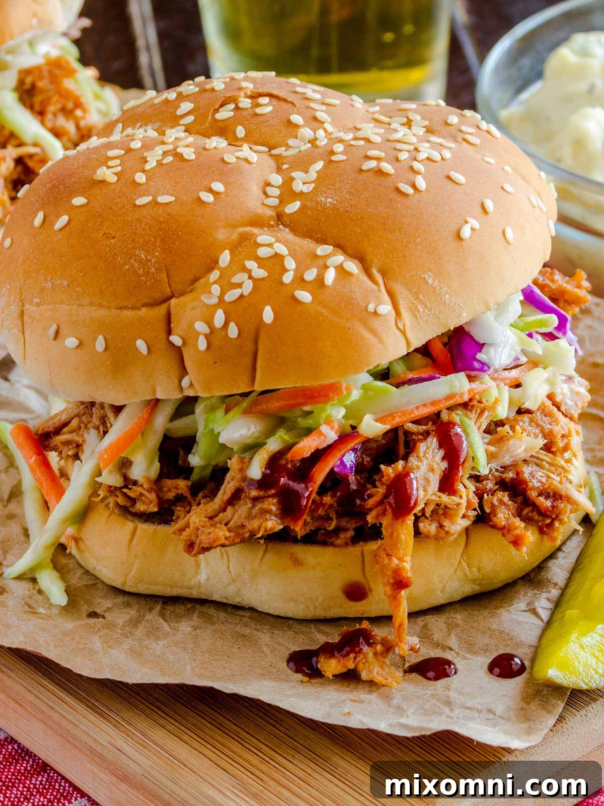 A mouth-watering pulled pork sandwich, generously topped with creamy coleslaw, showcasing a perfect balance of textures and flavors.