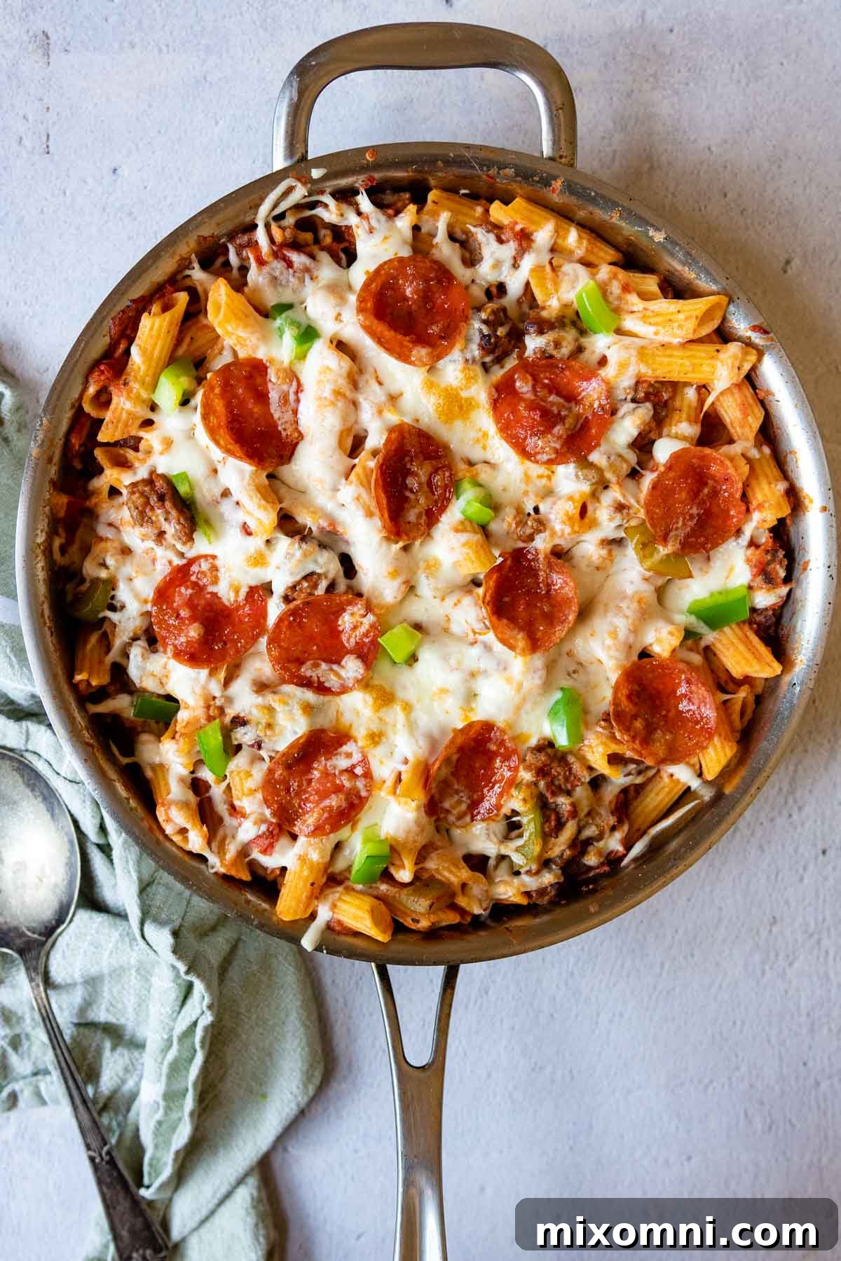 Overhead shot of the finished baked pizza pasta skillet with crispy pepperoni on top, ready to be served.