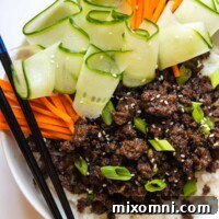overhead shot of bulgogi with carrots, green onions, and cucumbers.