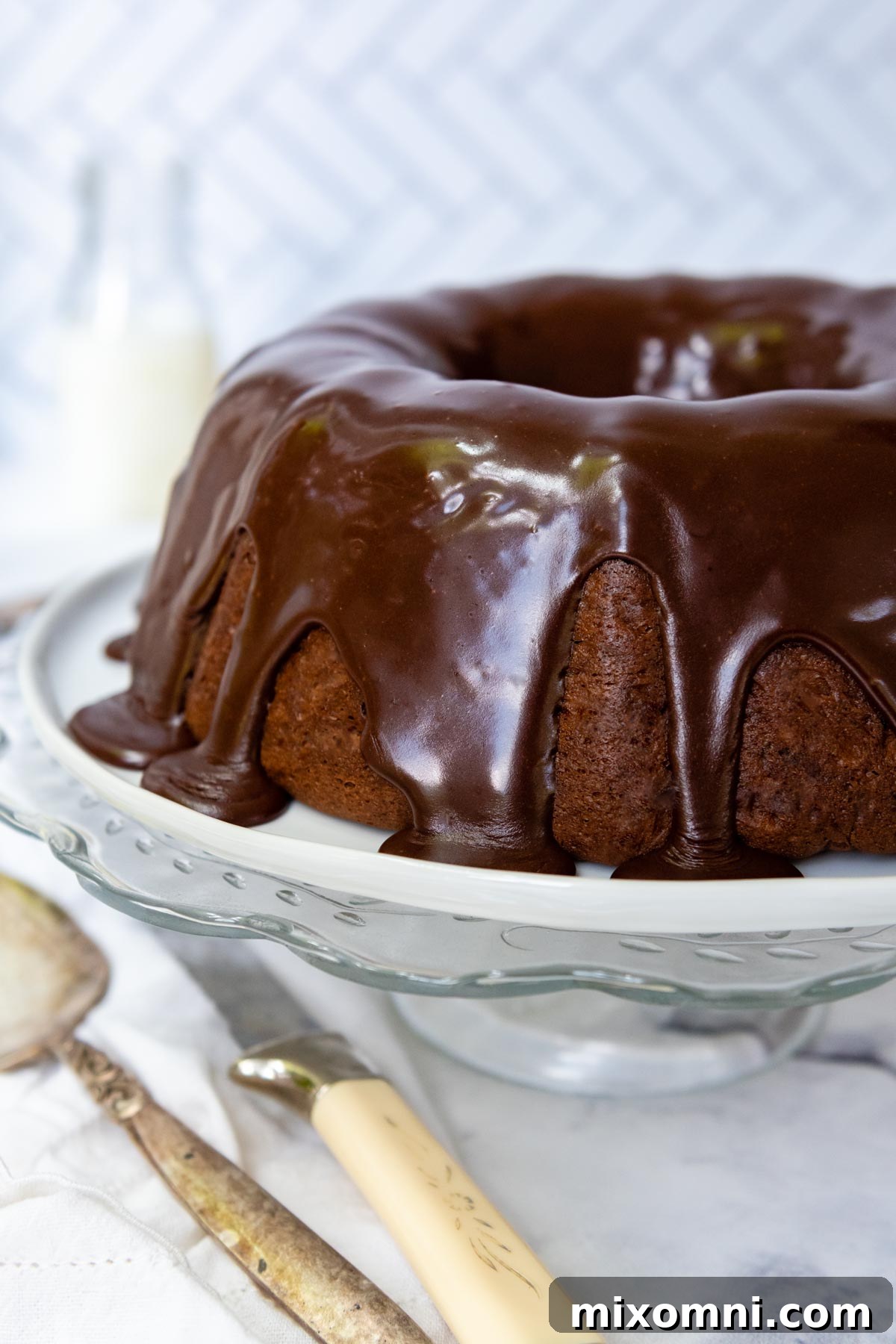 A rich chocolate glaze drizzled generously over the cooled gluten-free bundt cake.