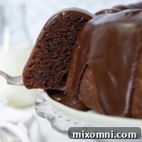A slice of gluten-free chocolate bundt cake being pulled for a platter.