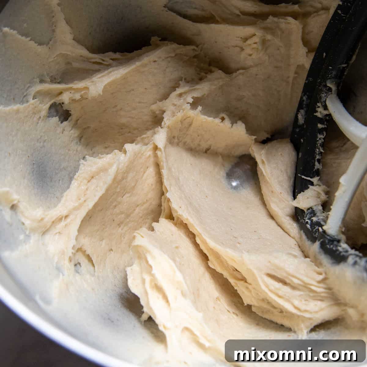 The perfectly mixed gluten-free dough in a stand mixer bowl, ready for shaping.