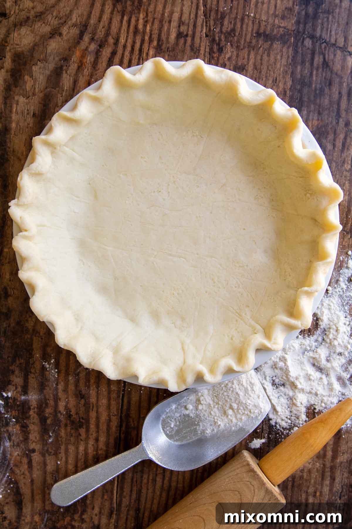 overhead shot of gluten free pie crust on a wooden surface.