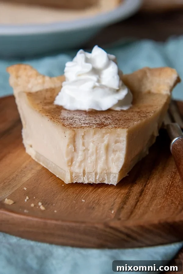 a close up of a slice of indiana sugar cream pie with a bite taken out on a plate