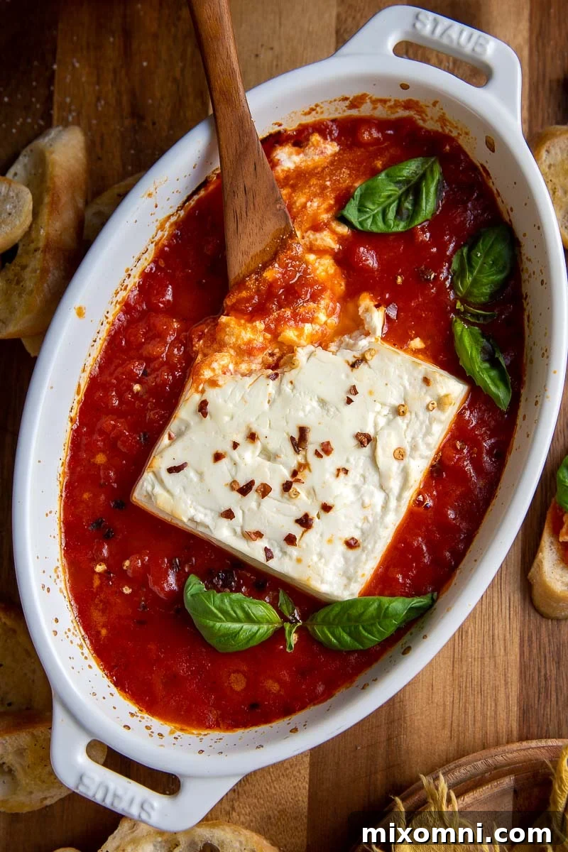 overhead shot of baked feta in a small dish with marinara