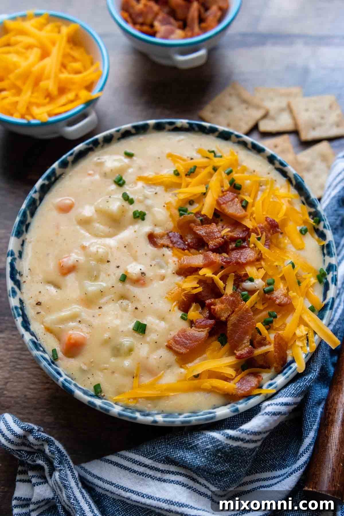 A beautifully presented bowl of thick and creamy gluten-free potato soup on a rustic wooden background, garnished simply to highlight its natural appeal.