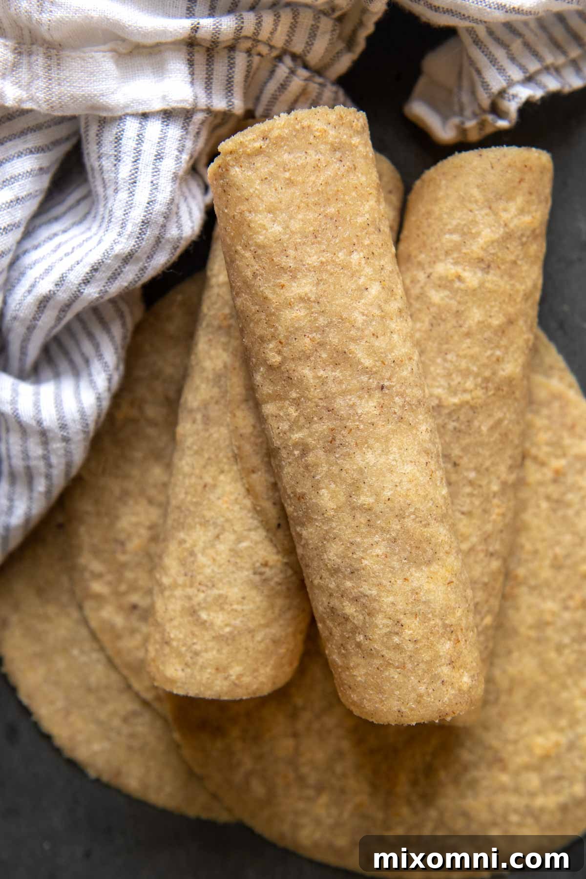 A stack of perfectly rolled and cooked almond flour tortillas.