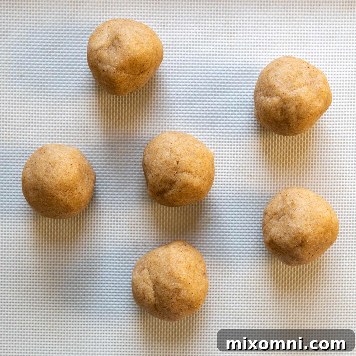 Six evenly shaped dough balls ready for rolling.