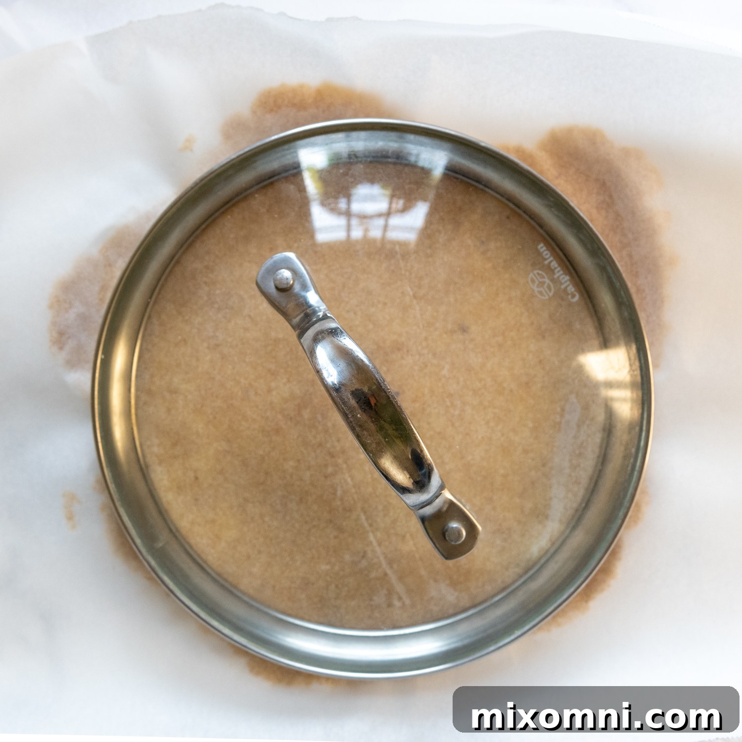 A lid being used to cut a perfectly round tortilla shape.